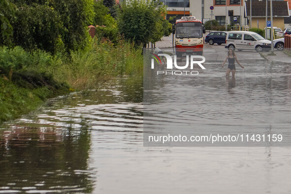 A street is flooding after a strong storm and downpour in Gdansk, Poland, on July 24, 2024. Heavy downpours and strong storms are causing nu...