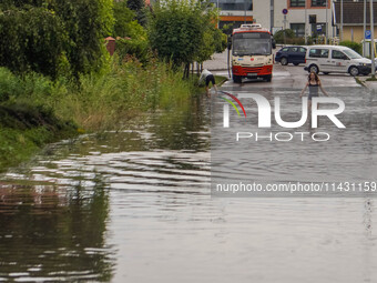 A street is flooding after a strong storm and downpour in Gdansk, Poland, on July 24, 2024. Heavy downpours and strong storms are causing nu...