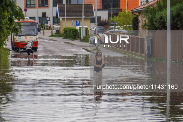 A street is flooding after a strong storm and downpour in Gdansk, Poland, on July 24, 2024. Heavy downpours and strong storms are causing nu...