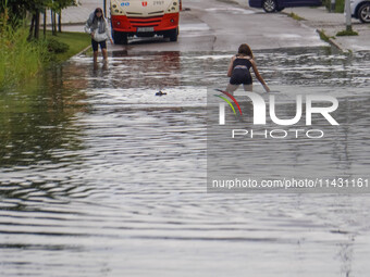 A street is flooding after a strong storm and downpour in Gdansk, Poland, on July 24, 2024. Heavy downpours and strong storms are causing nu...