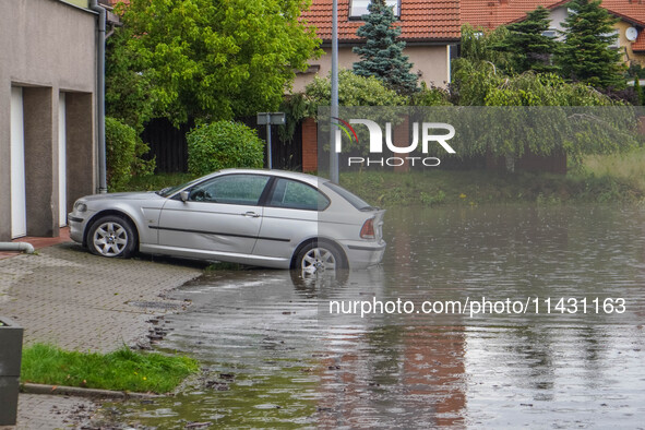 A street is flooding after a strong storm and downpour in Gdansk, Poland, on July 24, 2024. Heavy downpours and strong storms are causing nu...