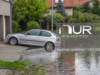 A street is flooding after a strong storm and downpour in Gdansk, Poland, on July 24, 2024. Heavy downpours and strong storms are causing nu...