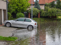 A street is flooding after a strong storm and downpour in Gdansk, Poland, on July 24, 2024. Heavy downpours and strong storms are causing nu...