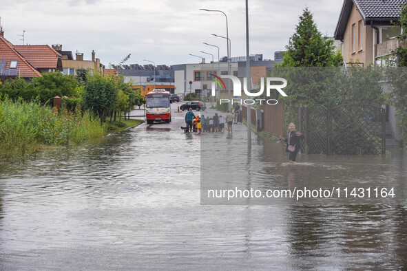 A street is flooding after a strong storm and downpour in Gdansk, Poland, on July 24, 2024. Heavy downpours and strong storms are causing nu...