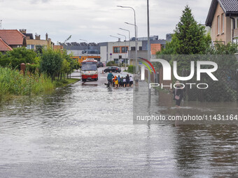 A street is flooding after a strong storm and downpour in Gdansk, Poland, on July 24, 2024. Heavy downpours and strong storms are causing nu...