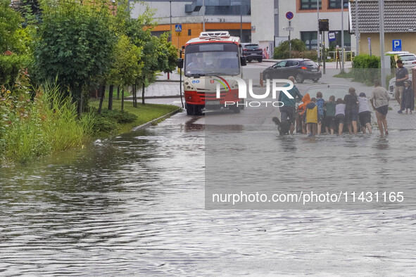 A street is flooding after a strong storm and downpour in Gdansk, Poland, on July 24, 2024. Heavy downpours and strong storms are causing nu...