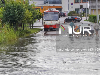 A street is flooding after a strong storm and downpour in Gdansk, Poland, on July 24, 2024. Heavy downpours and strong storms are causing nu...