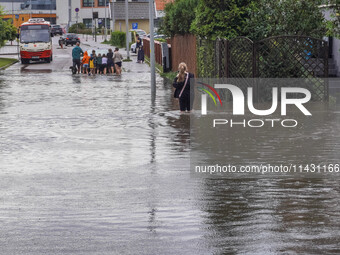 A street is flooding after a strong storm and downpour in Gdansk, Poland, on July 24, 2024. Heavy downpours and strong storms are causing nu...