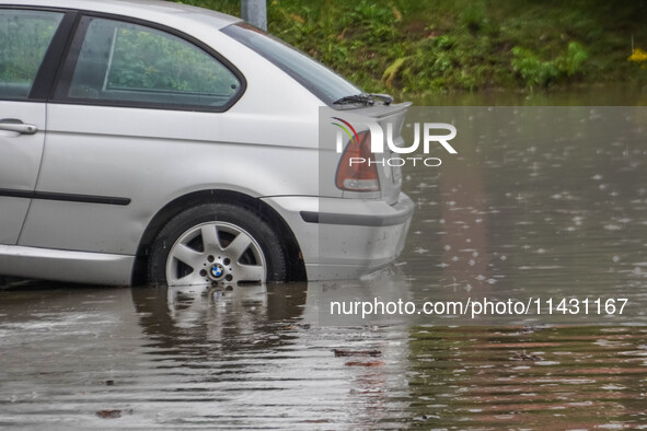 A street is flooding after a strong storm and downpour in Gdansk, Poland, on July 24, 2024. Heavy downpours and strong storms are causing nu...