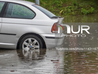 A street is flooding after a strong storm and downpour in Gdansk, Poland, on July 24, 2024. Heavy downpours and strong storms are causing nu...