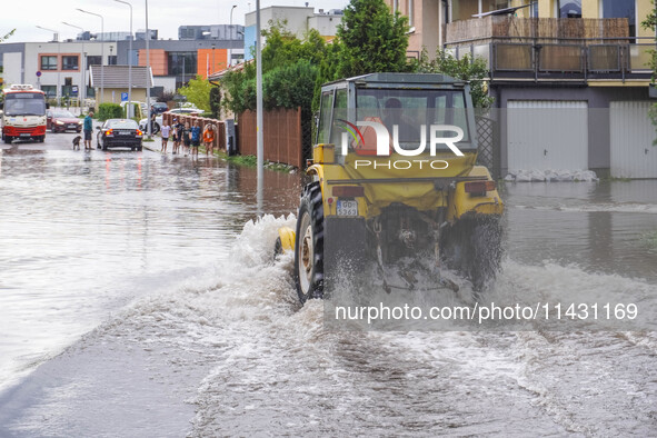 A street is flooding after a strong storm and downpour in Gdansk, Poland, on July 24, 2024. Heavy downpours and strong storms are causing nu...