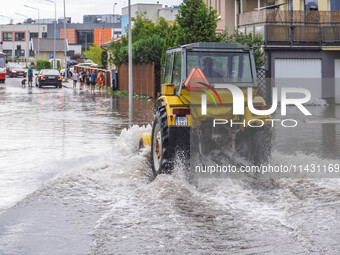 A street is flooding after a strong storm and downpour in Gdansk, Poland, on July 24, 2024. Heavy downpours and strong storms are causing nu...