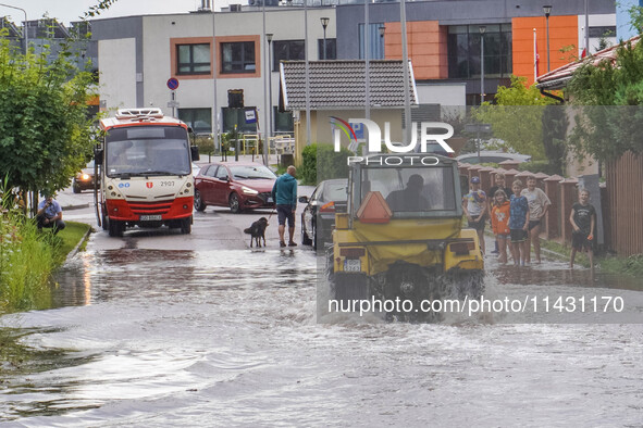 A street is flooding after a strong storm and downpour in Gdansk, Poland, on July 24, 2024. Heavy downpours and strong storms are causing nu...