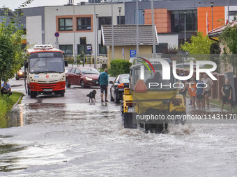 A street is flooding after a strong storm and downpour in Gdansk, Poland, on July 24, 2024. Heavy downpours and strong storms are causing nu...