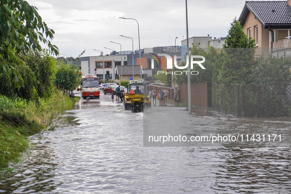 A street is flooding after a strong storm and downpour in Gdansk, Poland, on July 24, 2024. Heavy downpours and strong storms are causing nu...