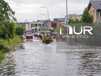 A street is flooding after a strong storm and downpour in Gdansk, Poland, on July 24, 2024. Heavy downpours and strong storms are causing nu...