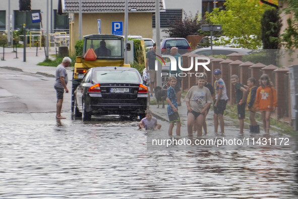 A street is flooding after a strong storm and downpour in Gdansk, Poland, on July 24, 2024. Heavy downpours and strong storms are causing nu...