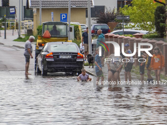 A street is flooding after a strong storm and downpour in Gdansk, Poland, on July 24, 2024. Heavy downpours and strong storms are causing nu...