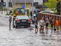 A street is flooding after a strong storm and downpour in Gdansk, Poland, on July 24, 2024. Heavy downpours and strong storms are causing nu...