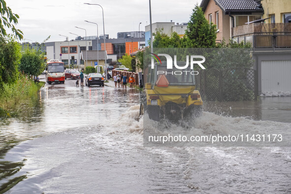 A street is flooding after a strong storm and downpour in Gdansk, Poland, on July 24, 2024. Heavy downpours and strong storms are causing nu...