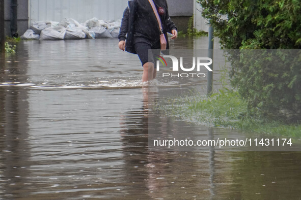 A street is flooding after a strong storm and downpour in Gdansk, Poland, on July 24, 2024. Heavy downpours and strong storms are causing nu...