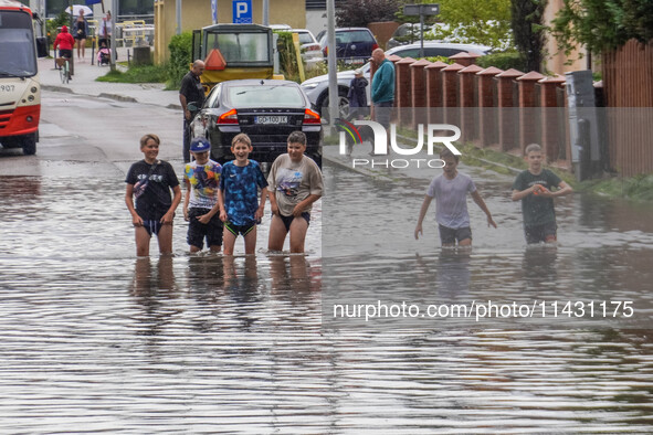 A street is flooding after a strong storm and downpour in Gdansk, Poland, on July 24, 2024. Heavy downpours and strong storms are causing nu...