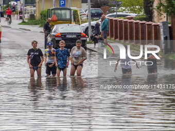 A street is flooding after a strong storm and downpour in Gdansk, Poland, on July 24, 2024. Heavy downpours and strong storms are causing nu...