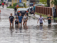 A street is flooding after a strong storm and downpour in Gdansk, Poland, on July 24, 2024. Heavy downpours and strong storms are causing nu...