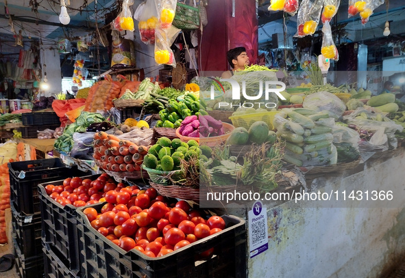 A person is selling vegetables inside a market in Kolkata, India, on July 24, 2024. 