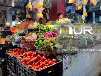 A person is selling vegetables inside a market in Kolkata, India, on July 24, 2024. (