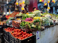 A person is selling vegetables inside a market in Kolkata, India, on July 24, 2024. (