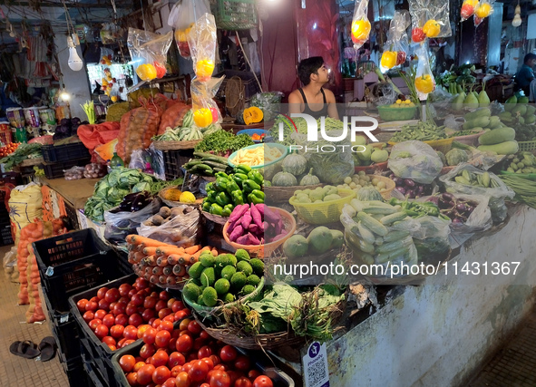 A person is selling vegetables inside a market in Kolkata, India, on July 24, 2024. 