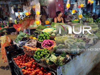 A person is selling vegetables inside a market in Kolkata, India, on July 24, 2024. (