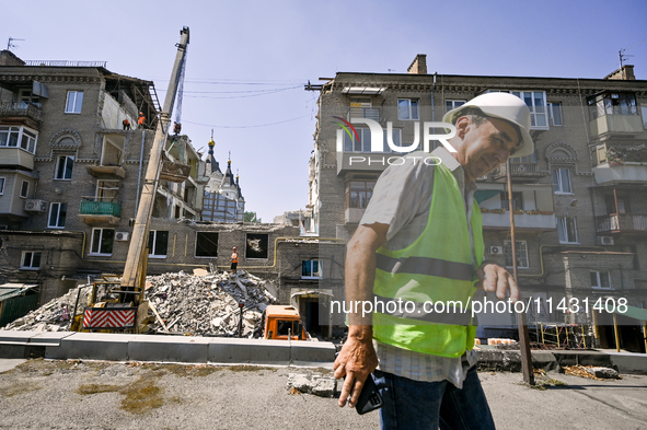 Workers are dismantling damaged structures as one of the sections of the five-storey apartment building at 44 Sobornyi Avenue that was destr...