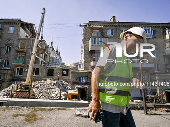 Workers are dismantling damaged structures as one of the sections of the five-storey apartment building at 44 Sobornyi Avenue that was destr...