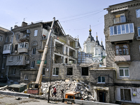 Workers are dismantling damaged structures as one of the sections of the five-storey apartment building at 44 Sobornyi Avenue that was destr...