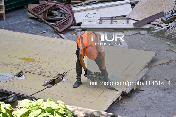 A builder is working to rebuild one of the sections of the five-storey apartment building at 44 Sobornyi Avenue that was destroyed by the Ru...