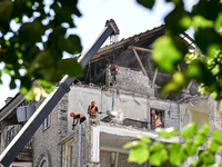 Workers are dismantling damaged structures as one of the sections of the five-storey apartment building at 44 Sobornyi Avenue that was destr...