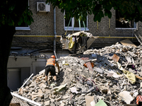 A worker is climbing a pile of rubble as one of the sections of the five-storey apartment building at 44 Sobornyi Avenue that was destroyed...