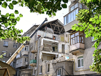 Workers are dismantling damaged structures as one of the sections of the five-storey apartment building at 44 Sobornyi Avenue that was destr...