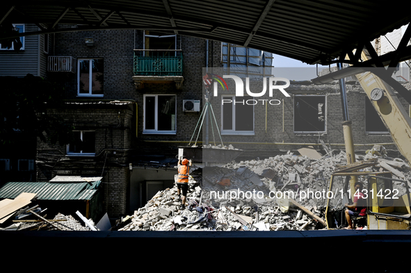 Workers are dismantling damaged structures as one of the sections of the five-storey apartment building at 44 Sobornyi Avenue that was destr...