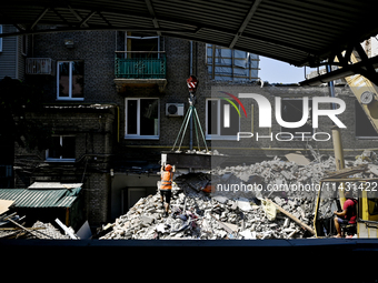 Workers are dismantling damaged structures as one of the sections of the five-storey apartment building at 44 Sobornyi Avenue that was destr...