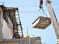 Workers are dismantling damaged structures as one of the sections of the five-storey apartment building at 44 Sobornyi Avenue that was destr...