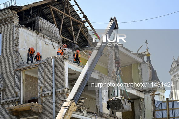 Workers are dismantling damaged structures as one of the sections of the five-storey apartment building at 44 Sobornyi Avenue that was destr...