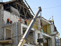 Workers are dismantling damaged structures as one of the sections of the five-storey apartment building at 44 Sobornyi Avenue that was destr...