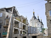 Workers are dismantling damaged structures as one of the sections of the five-storey apartment building at 44 Sobornyi Avenue that was destr...