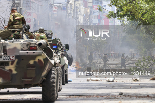 Bangladeshi military force soldiers are patrolling a street during a nationwide curfew in Dhaka, Bangladesh, on July 20, 2024. 