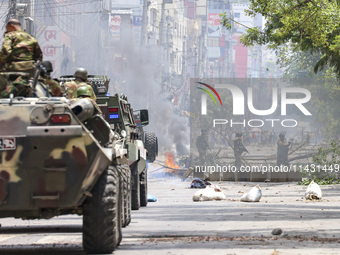 Bangladeshi military force soldiers are patrolling a street during a nationwide curfew in Dhaka, Bangladesh, on July 20, 2024. (