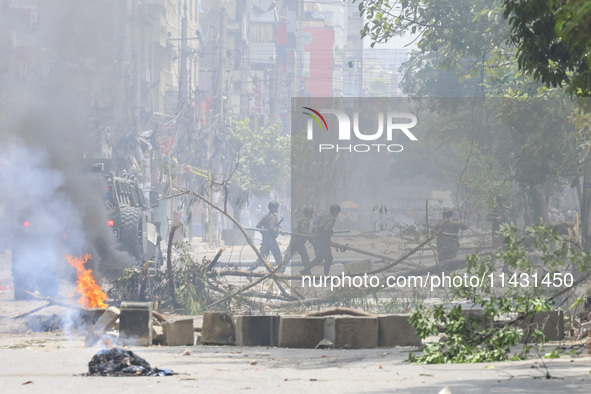 Bangladeshi military force soldiers are patrolling a street during a nationwide curfew in Dhaka, Bangladesh, on July 20, 2024. 