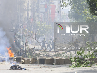 Bangladeshi military force soldiers are patrolling a street during a nationwide curfew in Dhaka, Bangladesh, on July 20, 2024. (